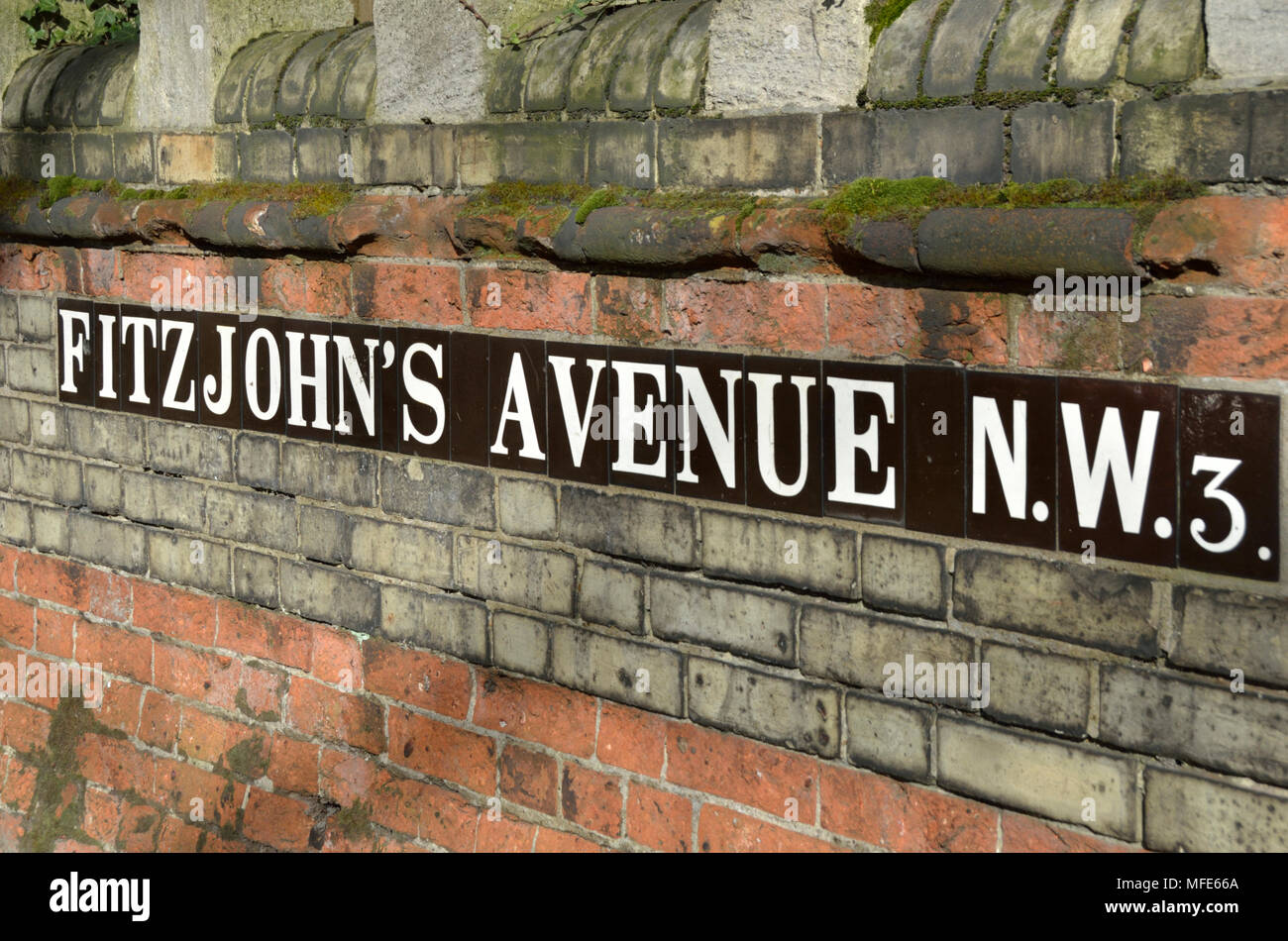 Fitzjohn’s Avenue NW3 street sign on a wall, Hampstead, London, UK. Stock Photo