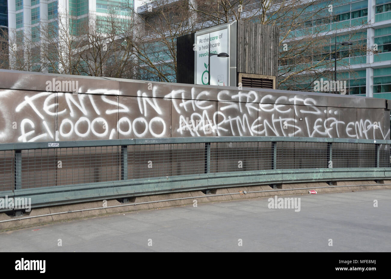 ’ Tents on the streets, million pound apartments left empty’ written on a wall, London, UK. Stock Photo