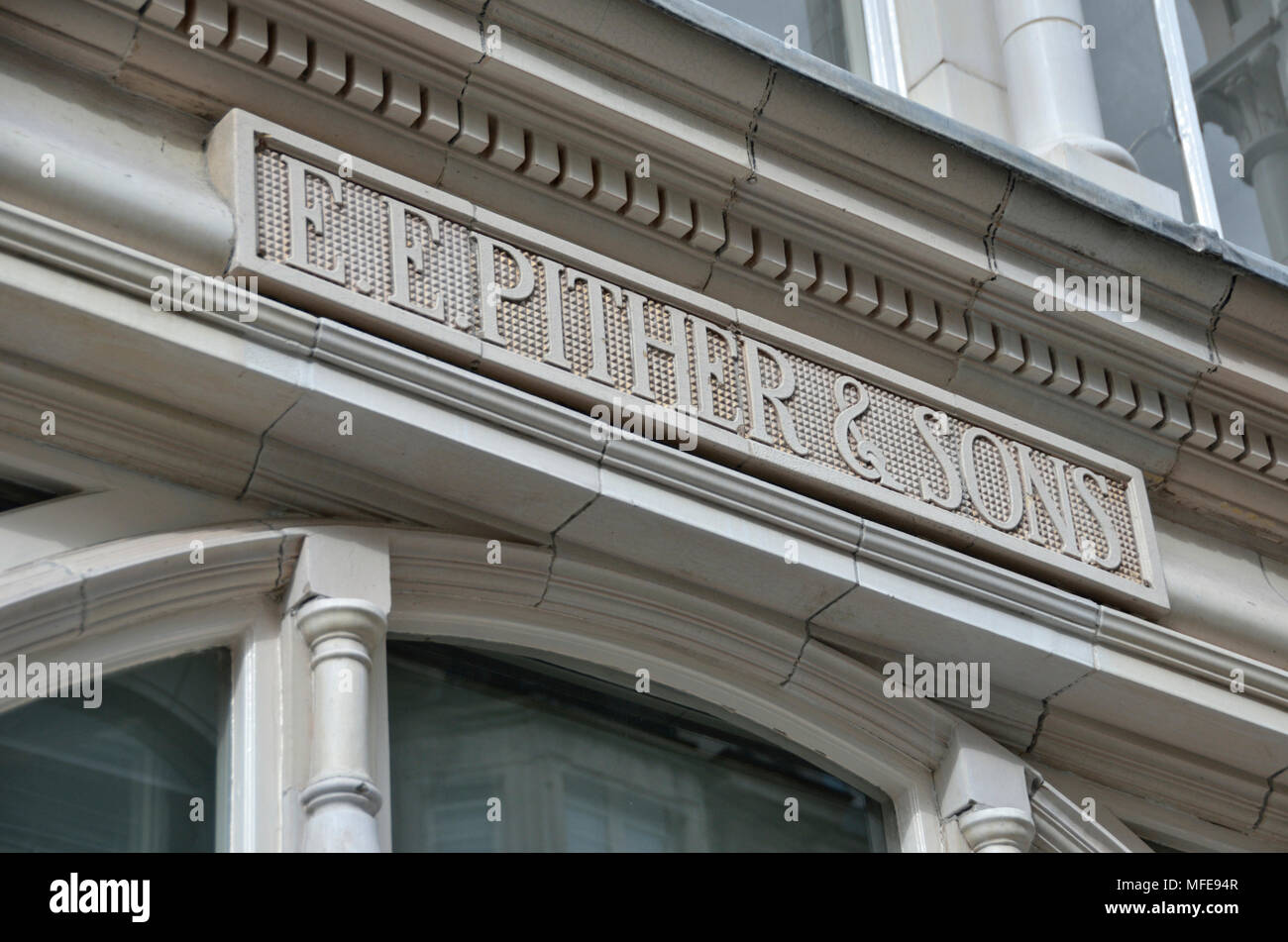 E E Pther and Sons carved stone sign, Radiant House, Mortimer Street, Fitzrovia, London, UK. Stock Photo