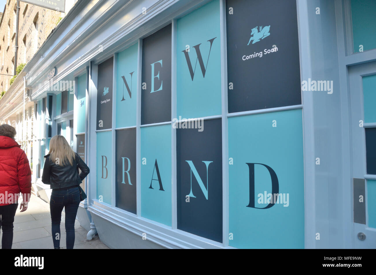 A large ’New Brand’ sign outside a shop. Stock Photo