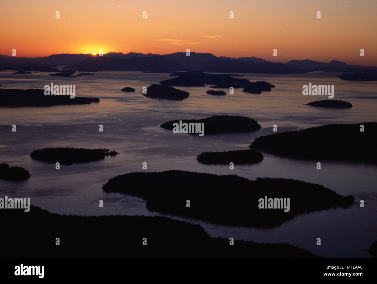 SAN JUAN ISLANDS at dusk Wasp Islands, aerial view Sun setting ovr Vancouver Island Washington, USA Stock Photo