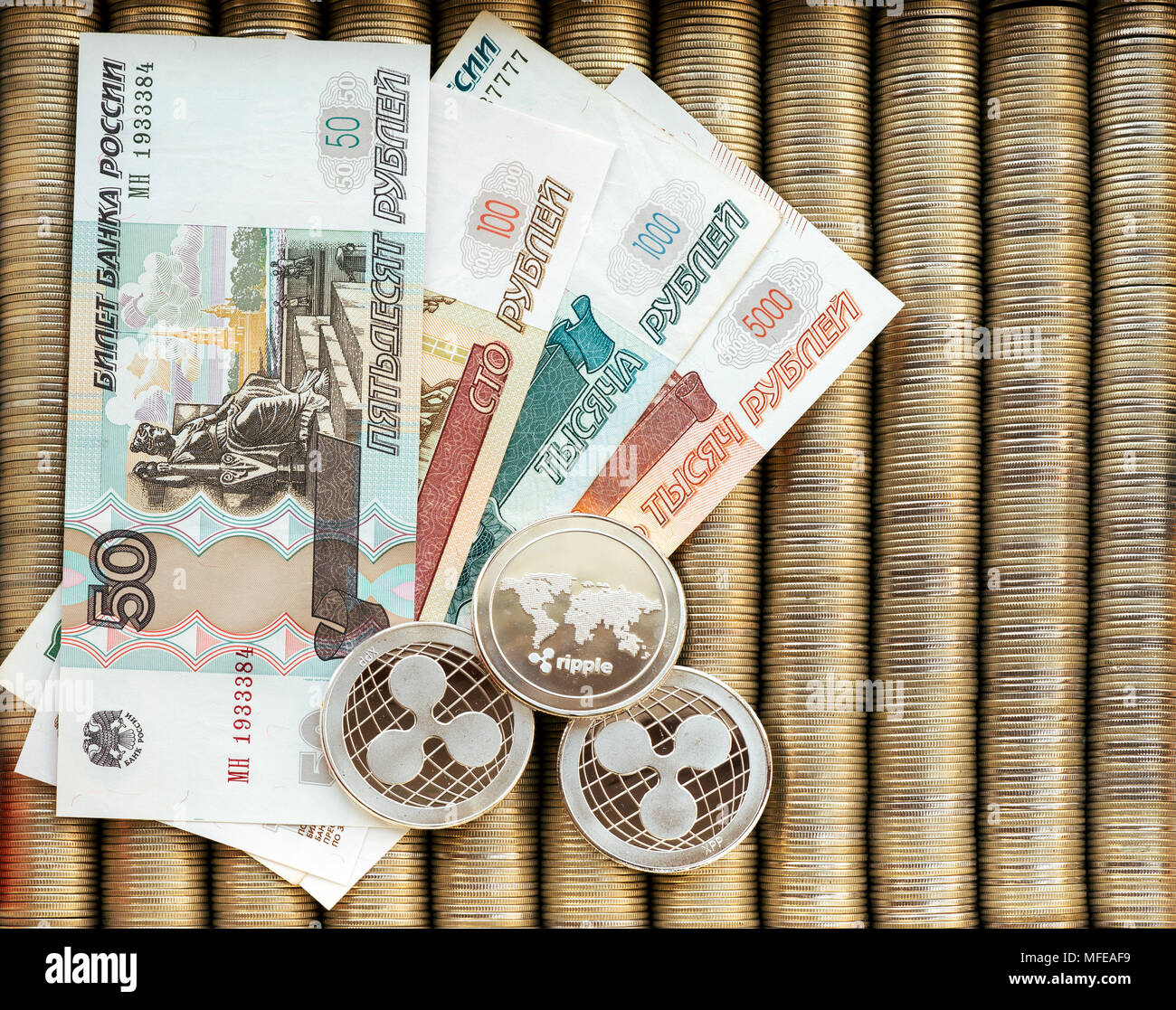 Silver crypto coins Ripple XRP, paper denominations of Russian rubles.  Metal coins are laid out in a smooth background to each other, close-up  view fr Stock Photo - Alamy