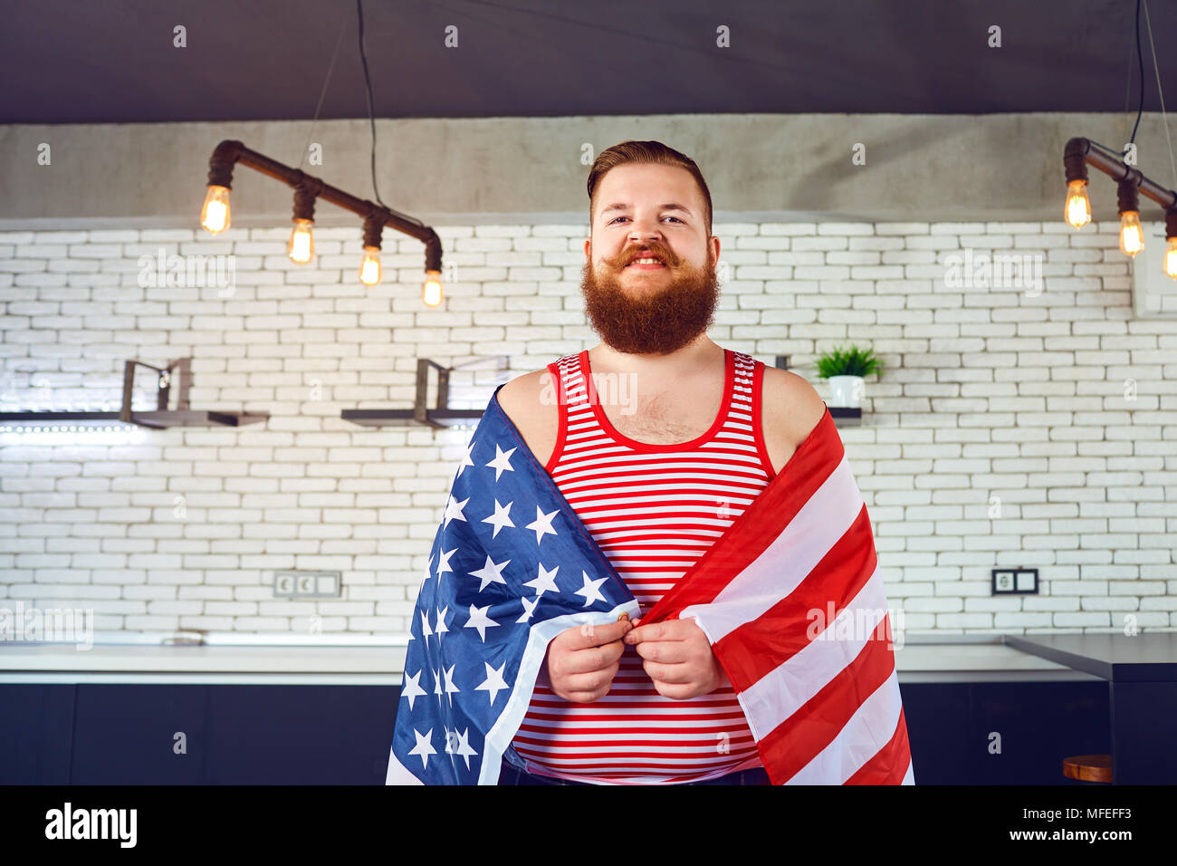 A fat man with a beard with an American flag.  Stock Photo