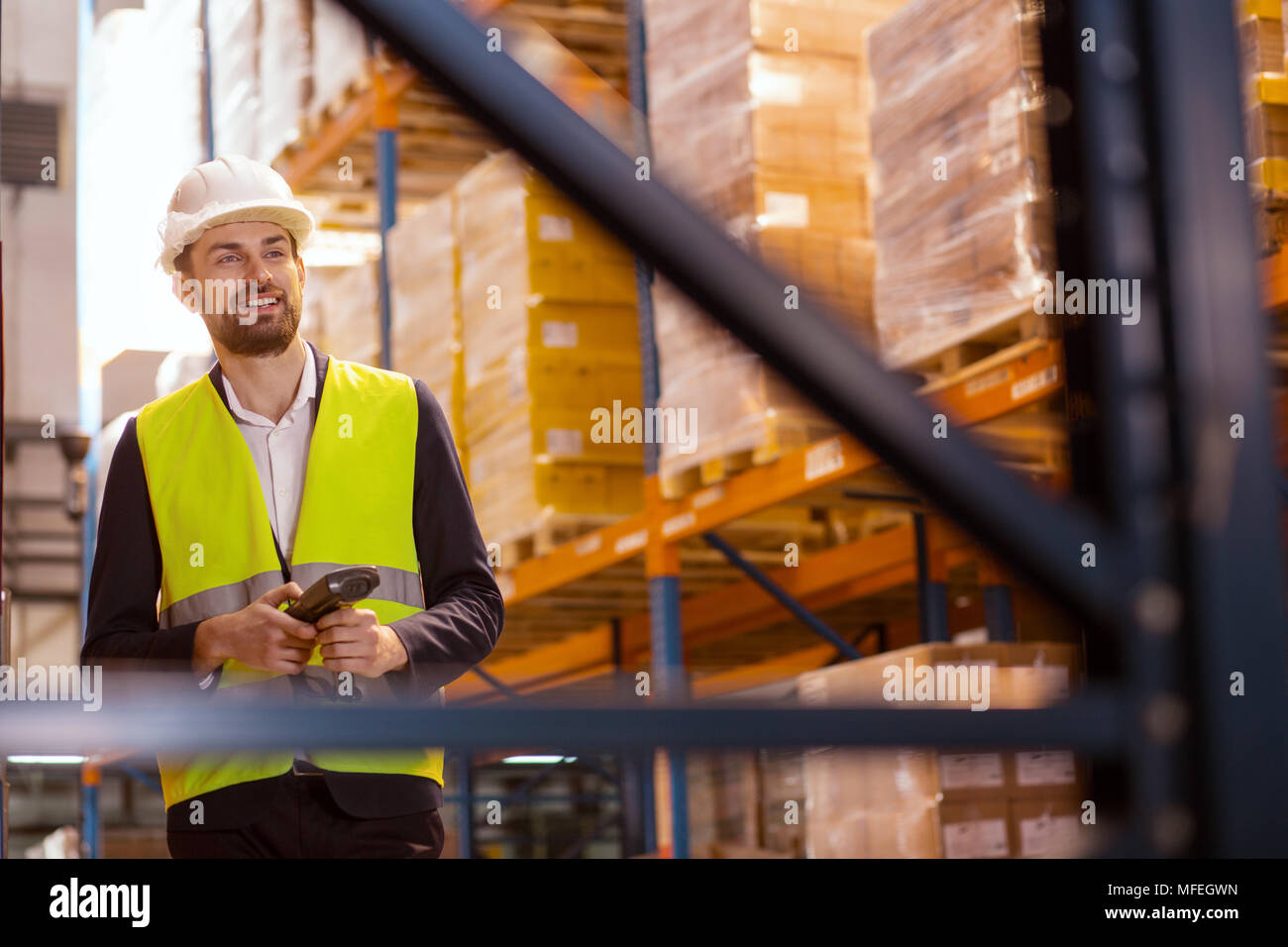 Positive nice man looking at the boxes Stock Photo