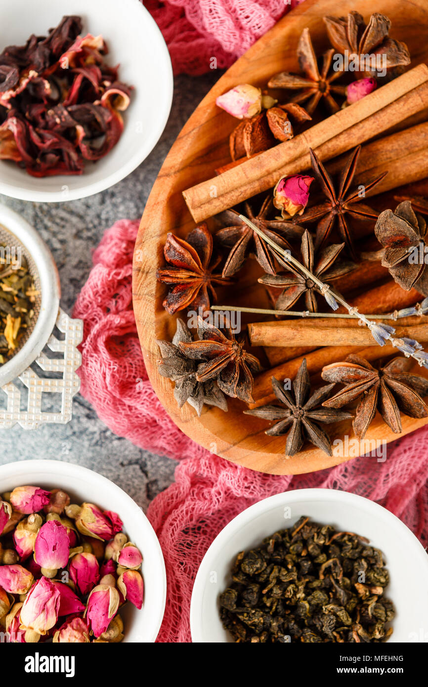 Collection of dry tea, rose buds tea, fruit tea, cinnamon, anise n bowls Stock Photo