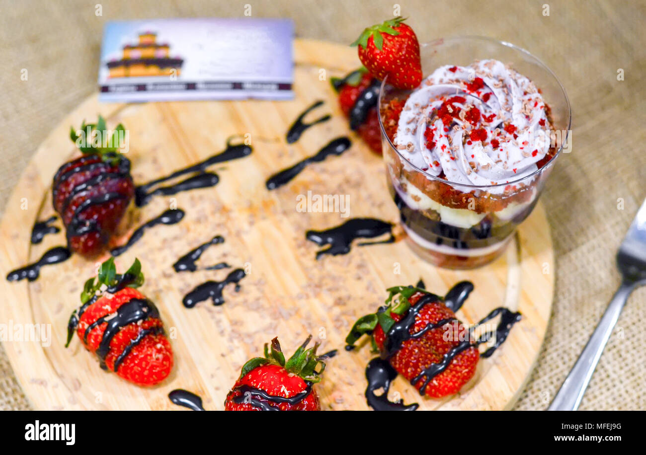 Sweet English Trifle Dessert with blueberry cream and strawberries on wooden stand and business card.Top view, flat lay.Burlap background. Stock Photo