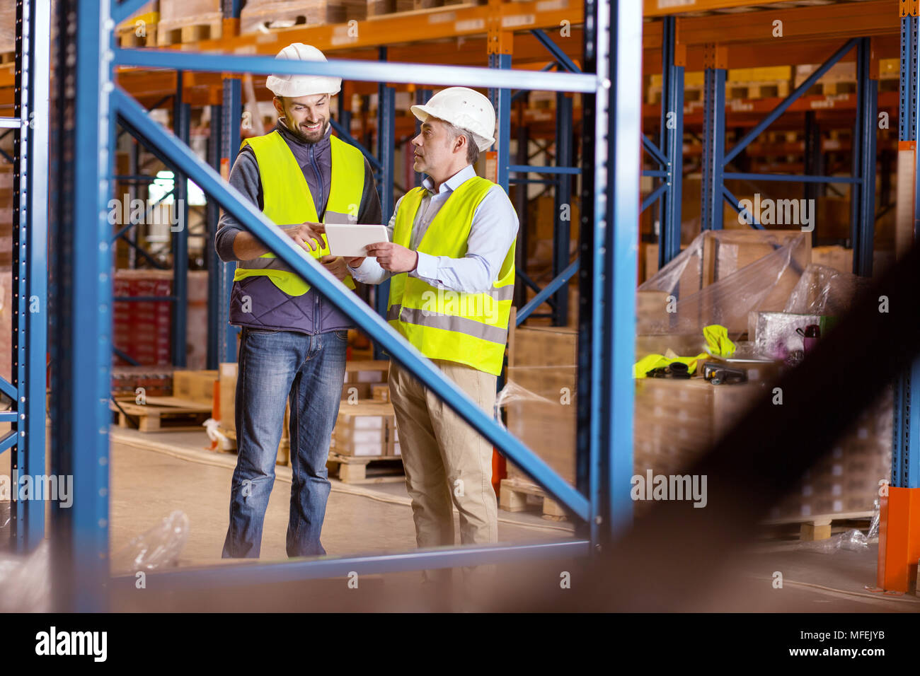 Positive nice man using a tablet Stock Photo - Alamy
