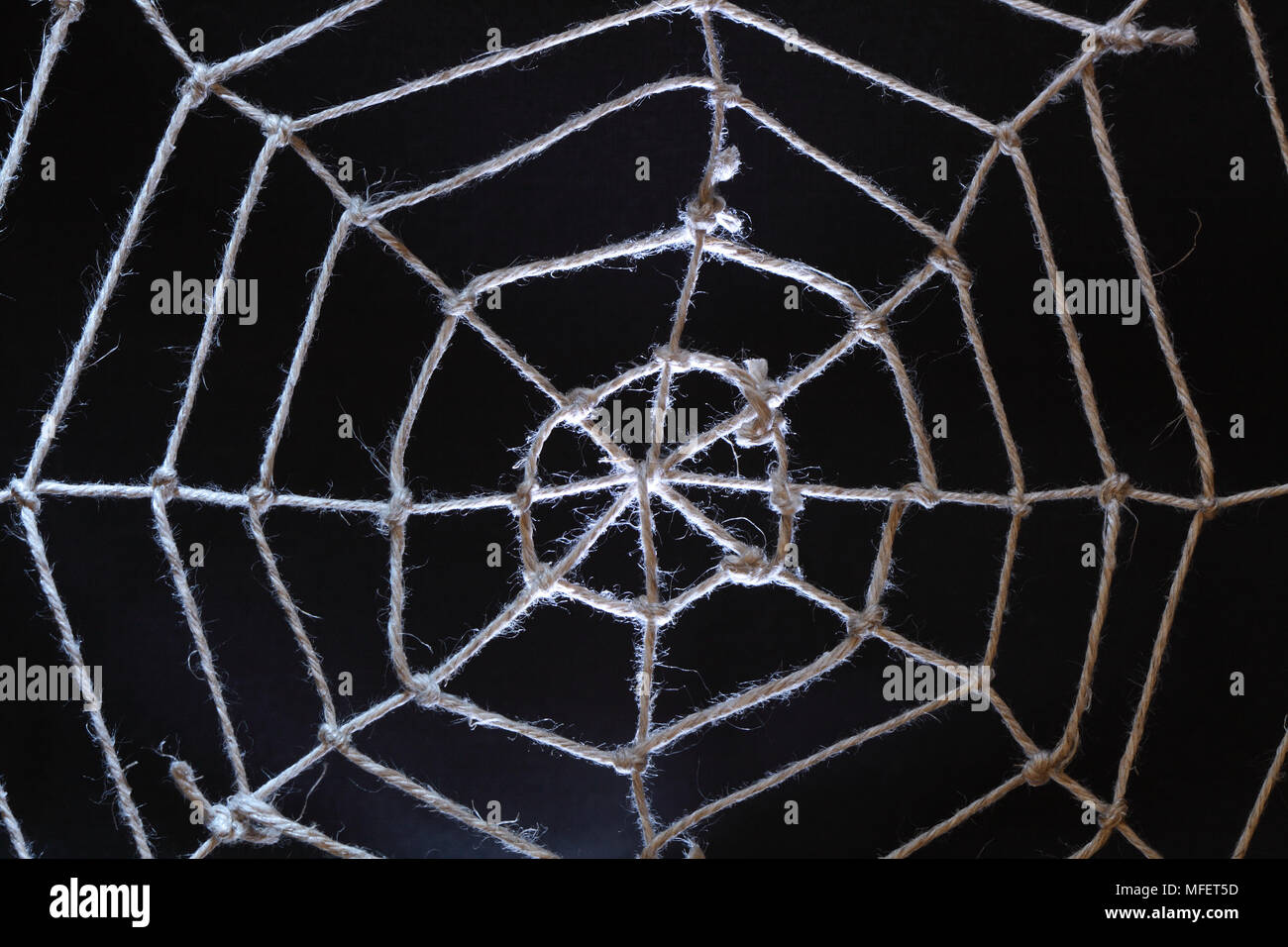 Conceptual background with web made from rope on dark Stock Photo