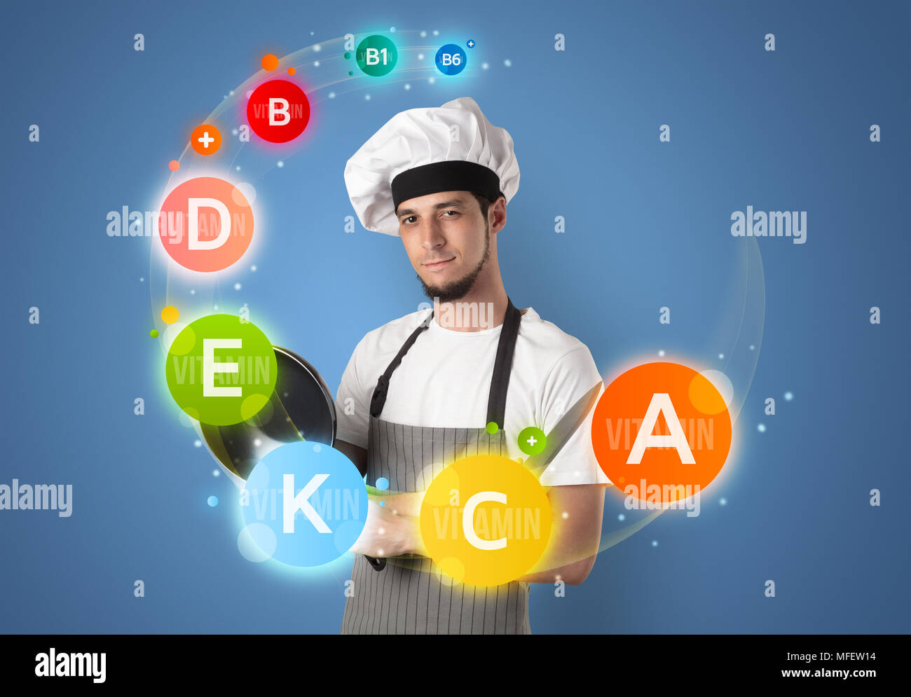 Handsome cook with kitchen instruments and vitamin concept Stock Photo ...