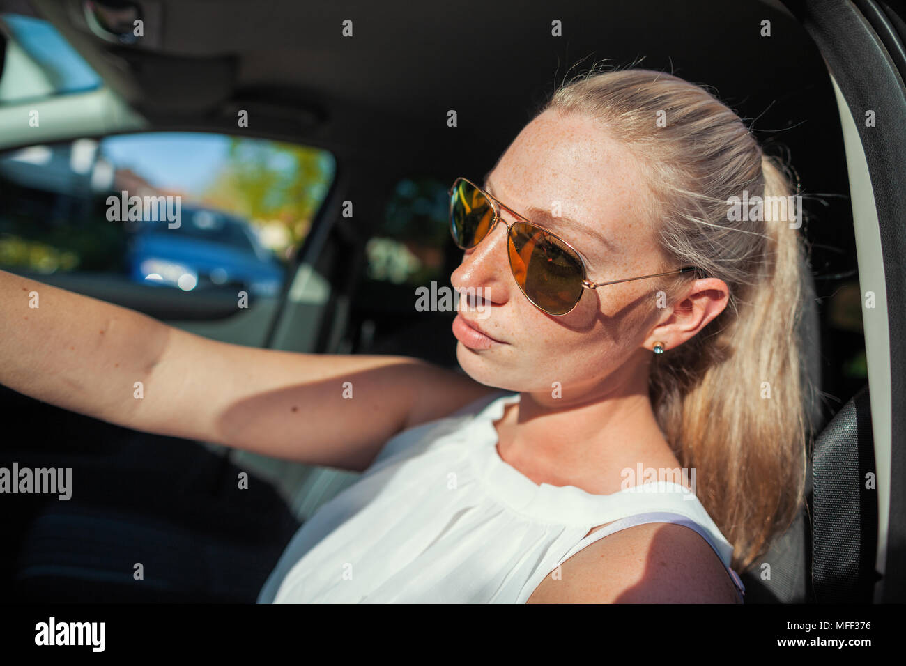 young woman with sunglasses in a car Stock Photo Alamy