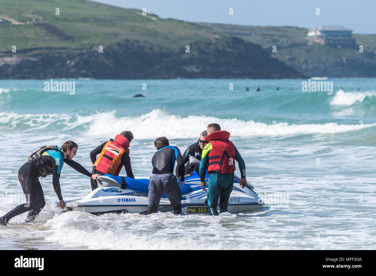 People helping to launch a jetski on Fistral Beach in Newquay in Cornmwall. Stock Photo