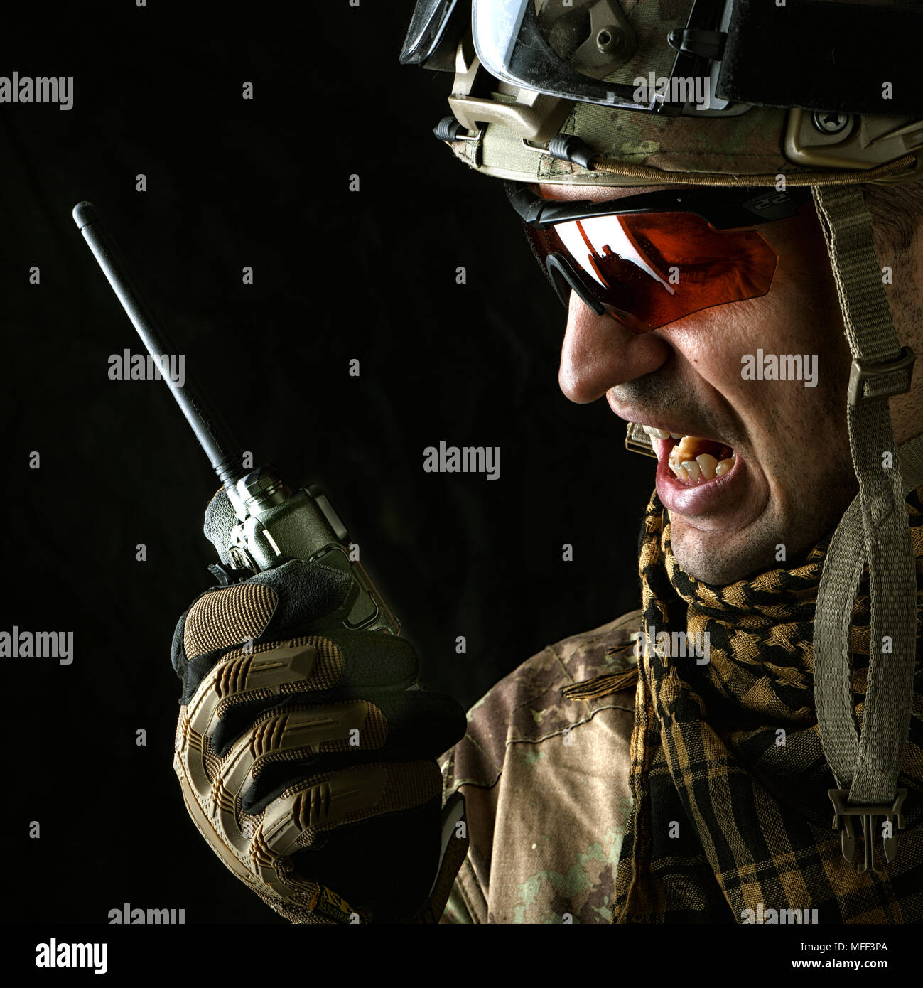 close up portrait of handsome military man. Macro shot on black background  with portable radio transceiver Stock Photo - Alamy