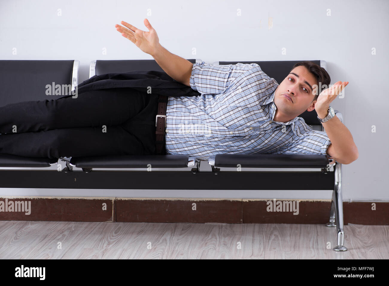 Man sleeping on the chairs in airport Stock Photo Alamy