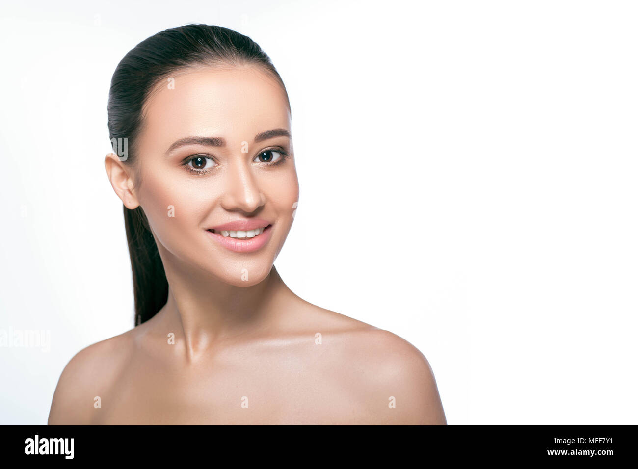 smiling face of young adult woman with clean fresh skin - isolated on white Stock Photo