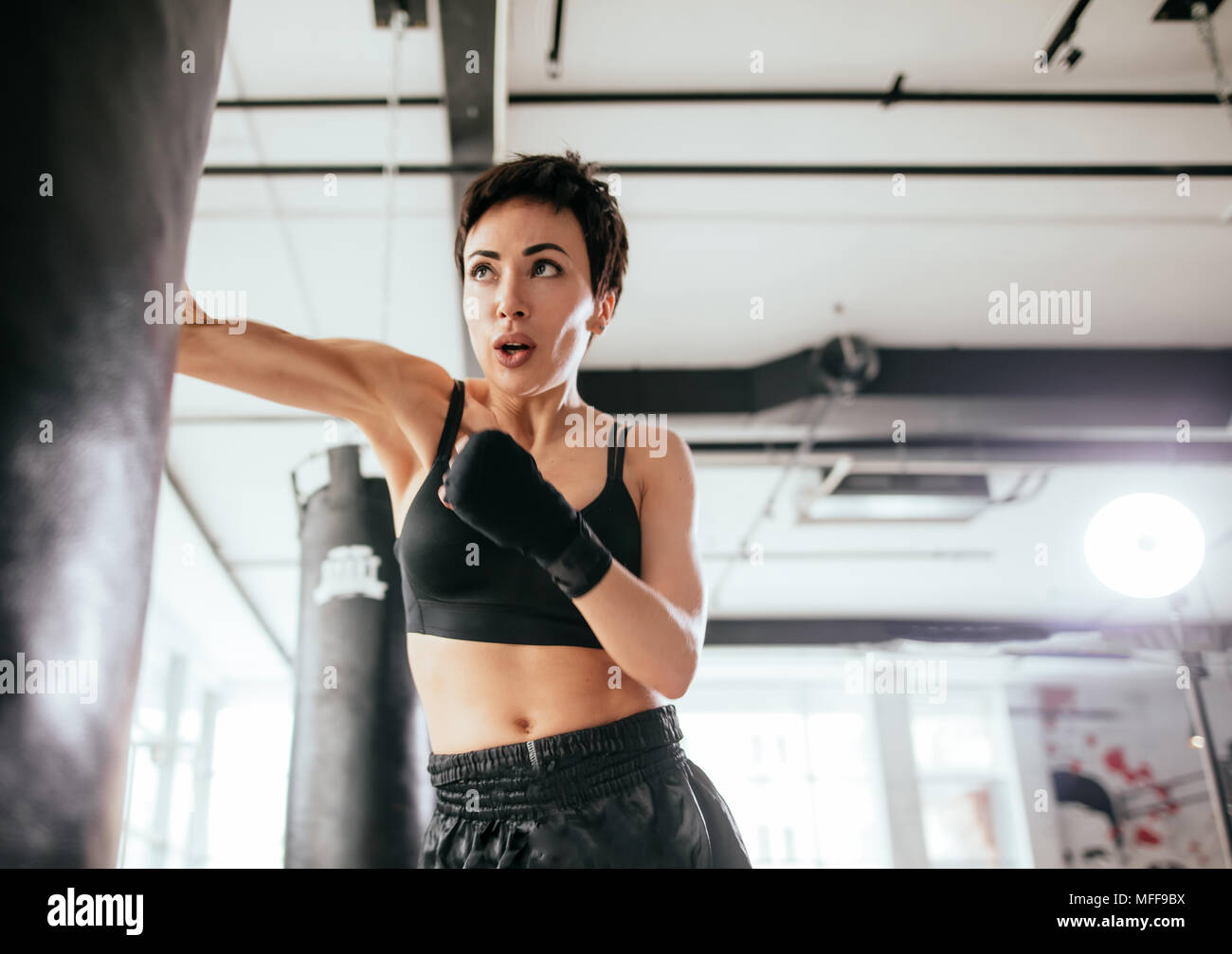 close up shot of practising right punch in boxing section. physically ...