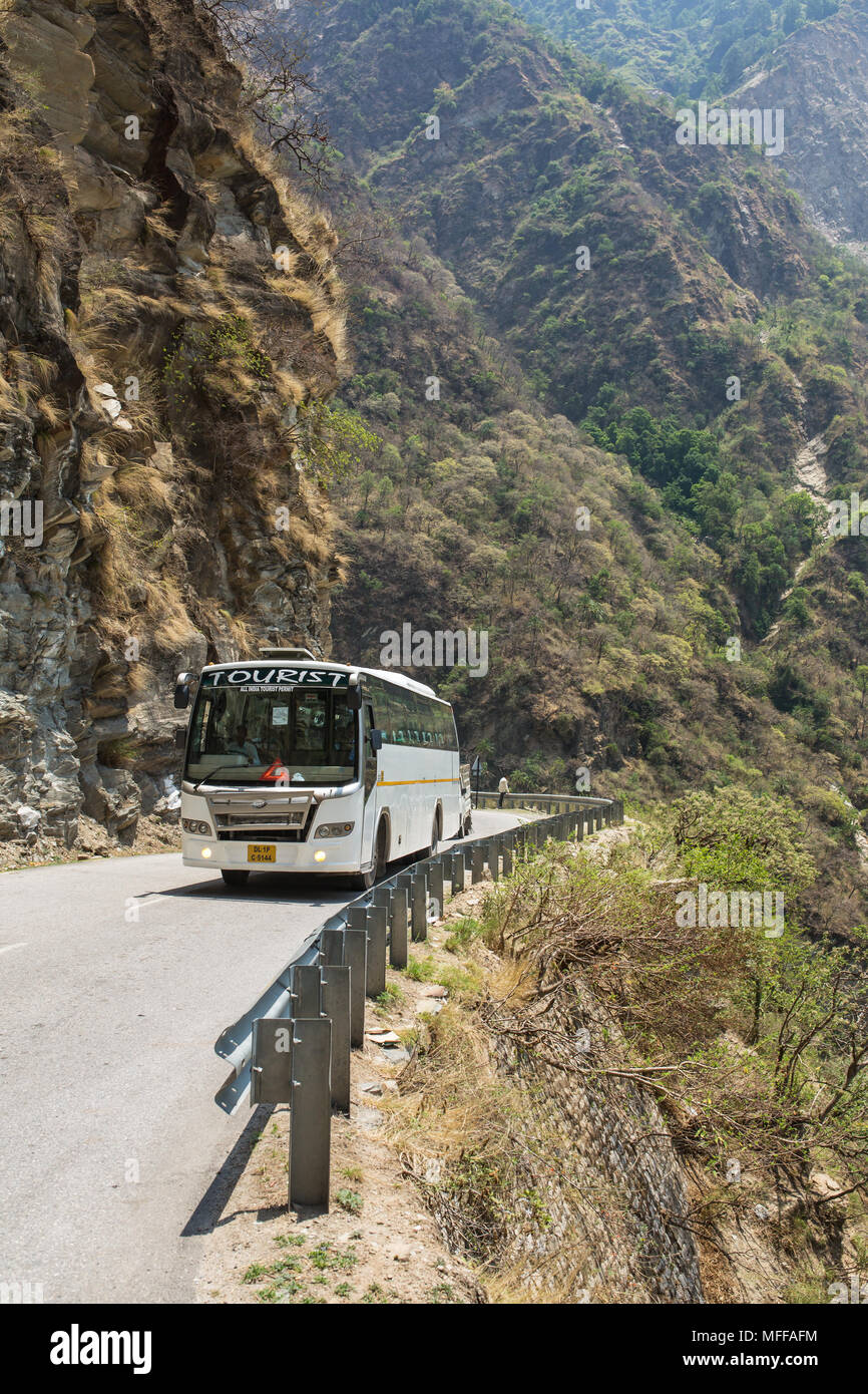Manali, India - May 25, 2017: Tourist bus driving on dangerous mountain road in Himalayas on the way from Mandi to Manali Stock Photo