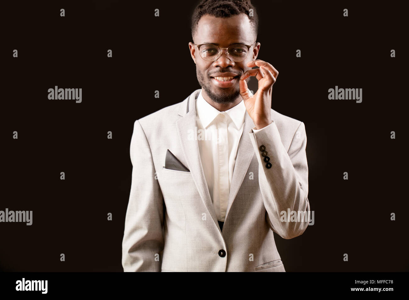 close up portrait of smart African man pulling out his hairs from beard