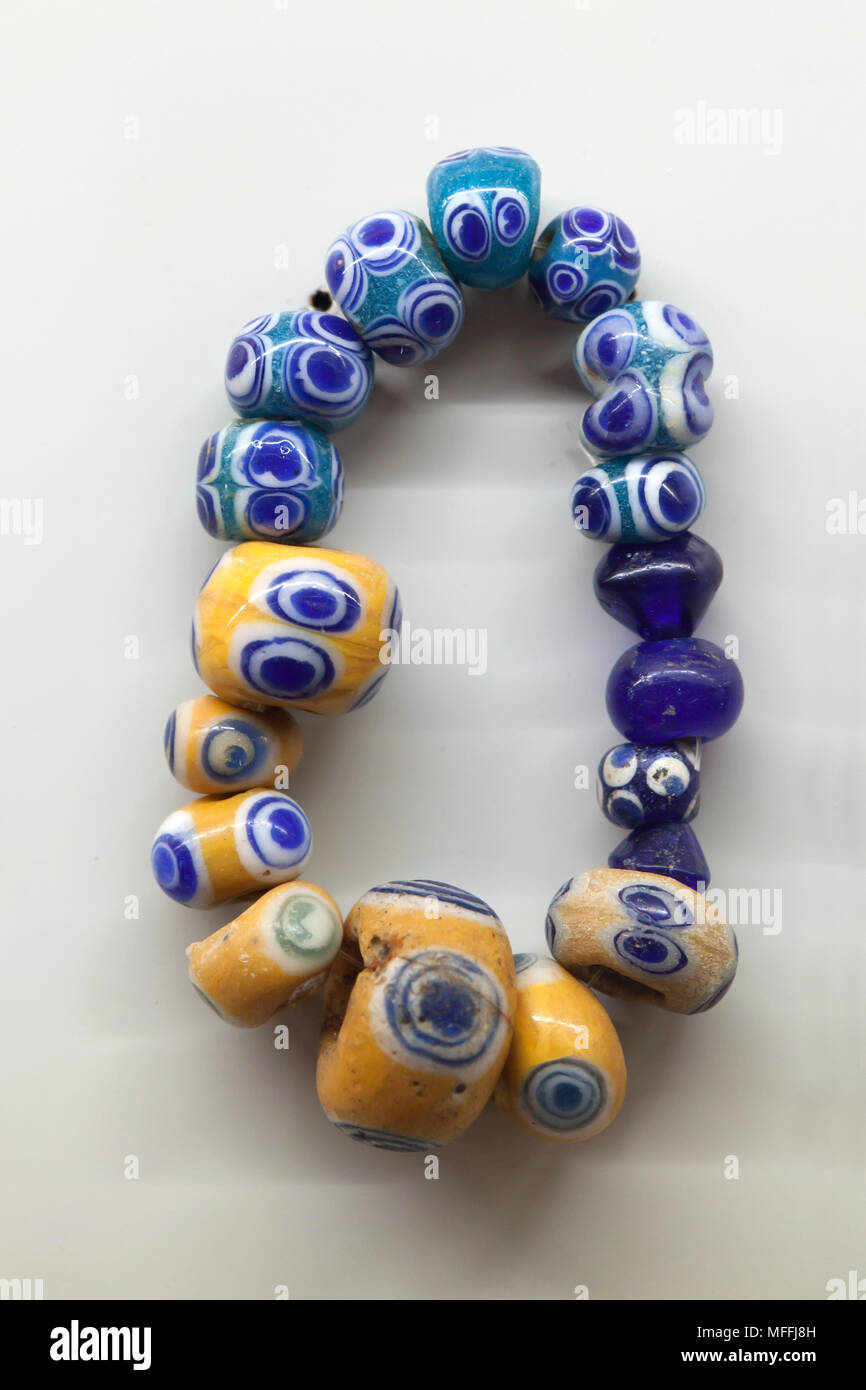 Ancient Egyptian glass necklace dated from the 8th century BC on display in the National Archaeological Museum (Museo Archeologico Nazionale di Napoli) in Naples, Campania, Italy. Stock Photo