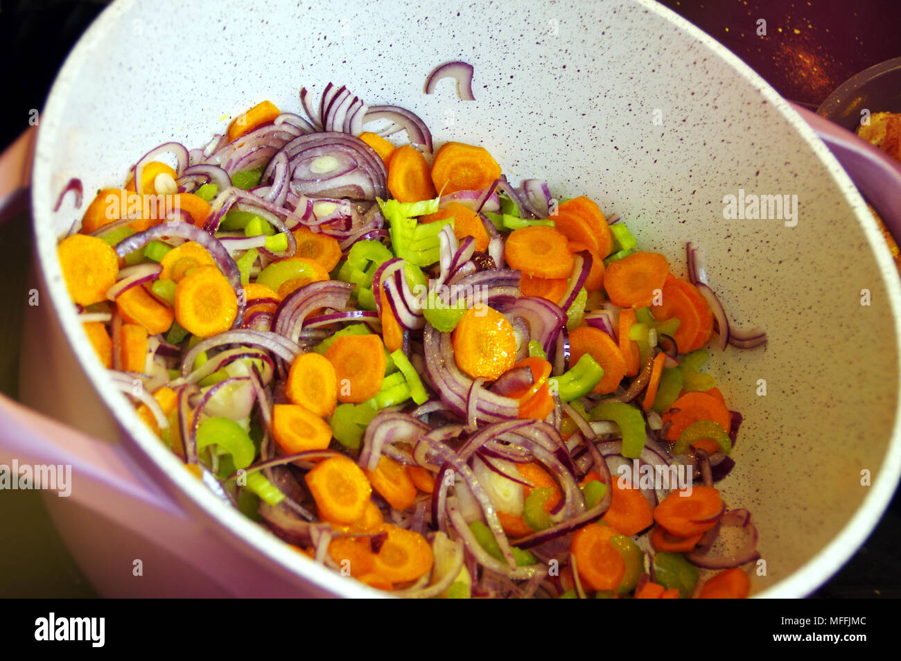 Fresh vegetables in a pot. Fried carrot, onion, celery and red pepper
