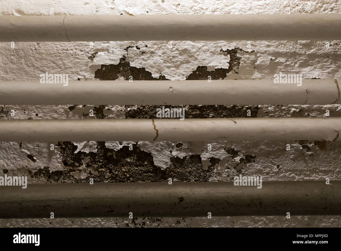 Paint comes off the wall behind pipes Stock Photo Alamy