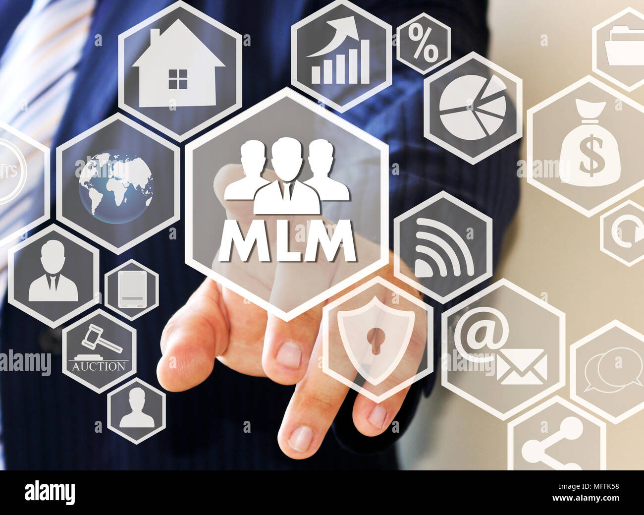 The businessman clicks the button MLM on the touch screen . The concept of multi-level marketing. Stock Photo