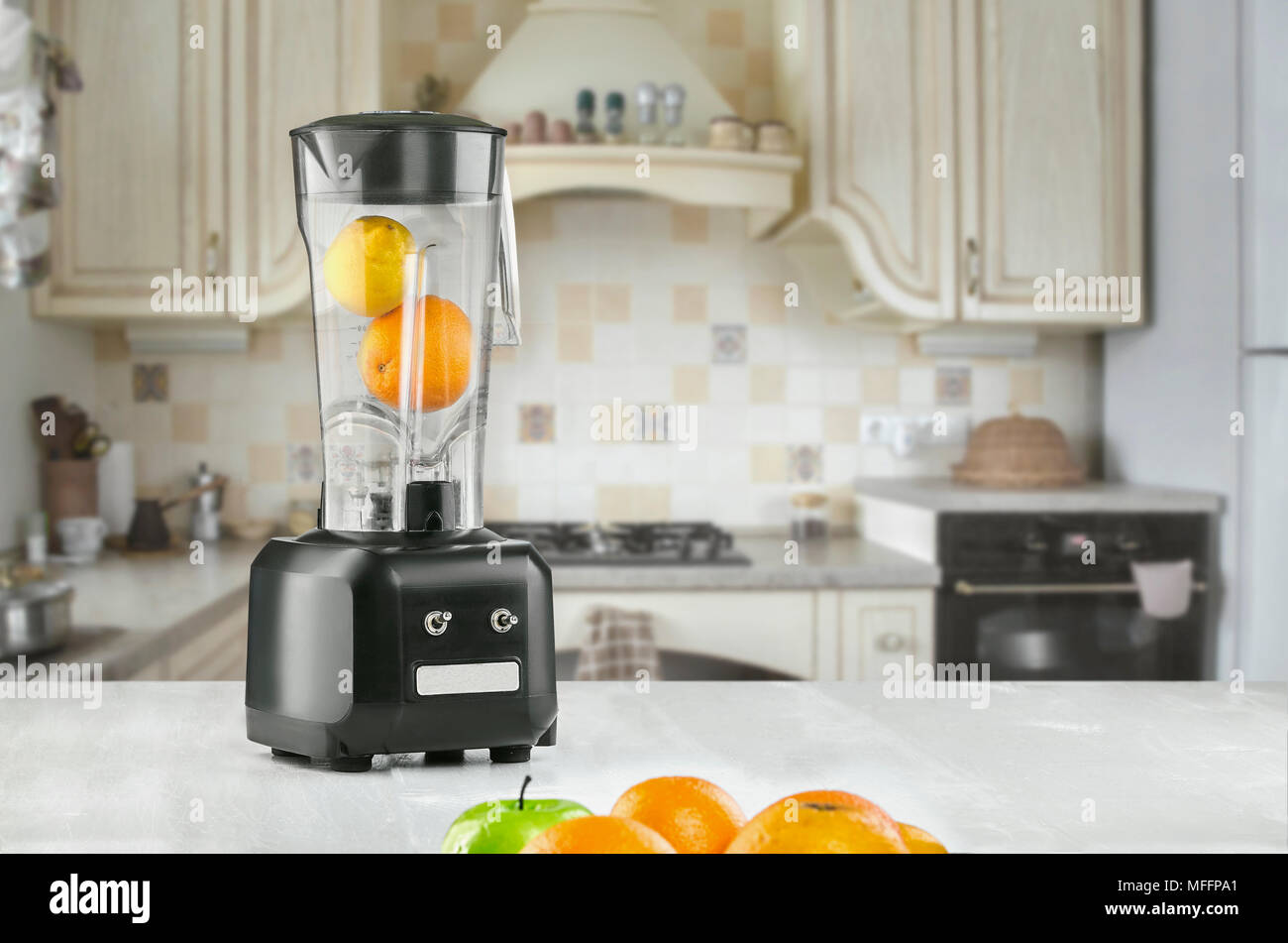 Orange juice blender machine in the kitchen interior Stock Photo Alamy