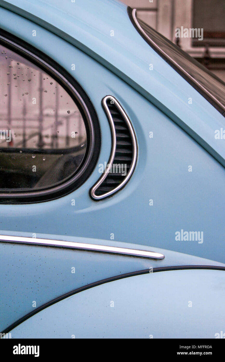 A detail close up of a vintage blue VW beetle / bug on a London street, shows curves and lines of the classic design, almost abstract still life. Stock Photo