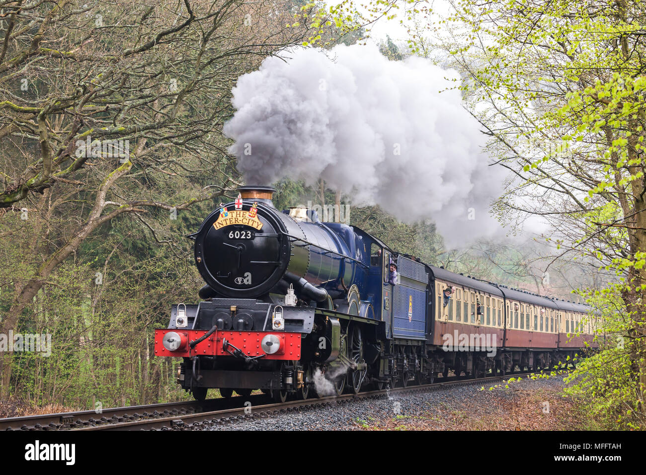 Front view of vintage UK steam locomotive King Edward II, puffing through Worcestershire woodland countryside on Severn Valley Railway heritage line. Stock Photo