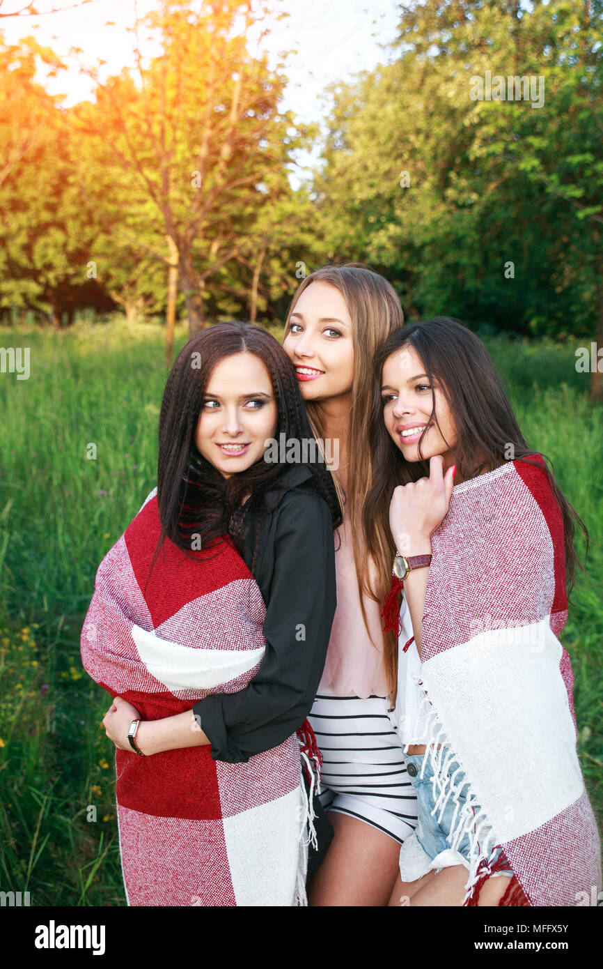 Three cute girls standing in the plaid outdoors, best friends ...