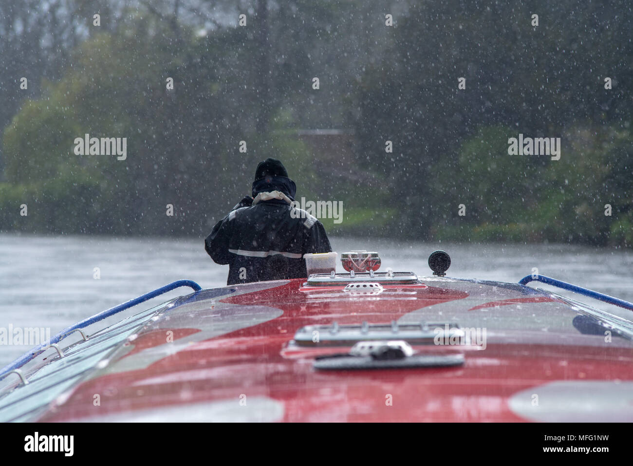 man on bow of boat in the a rain storm Stock Photo Alamy