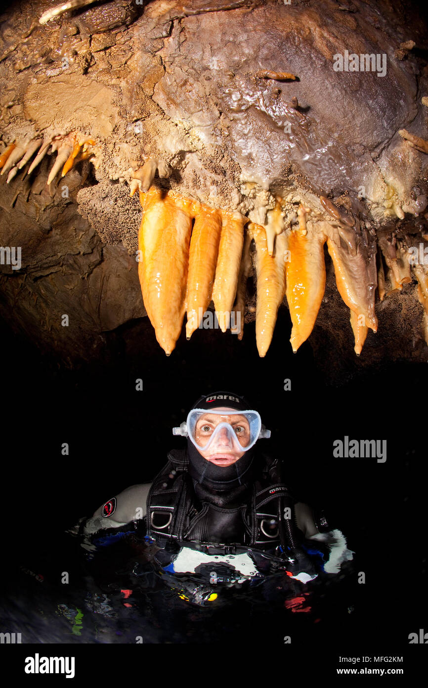 Scuba diver inside Jabula cave that is located outside the island of Kolocep, on the side facing the open sea. The entrance is located just below the Stock Photo