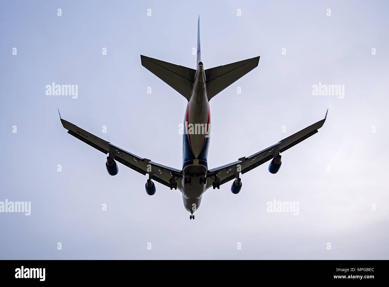A Boeing 747-428 Cargo Airplane belonging to and operated by CargoLogicAir flys over head and away. Stock Photo