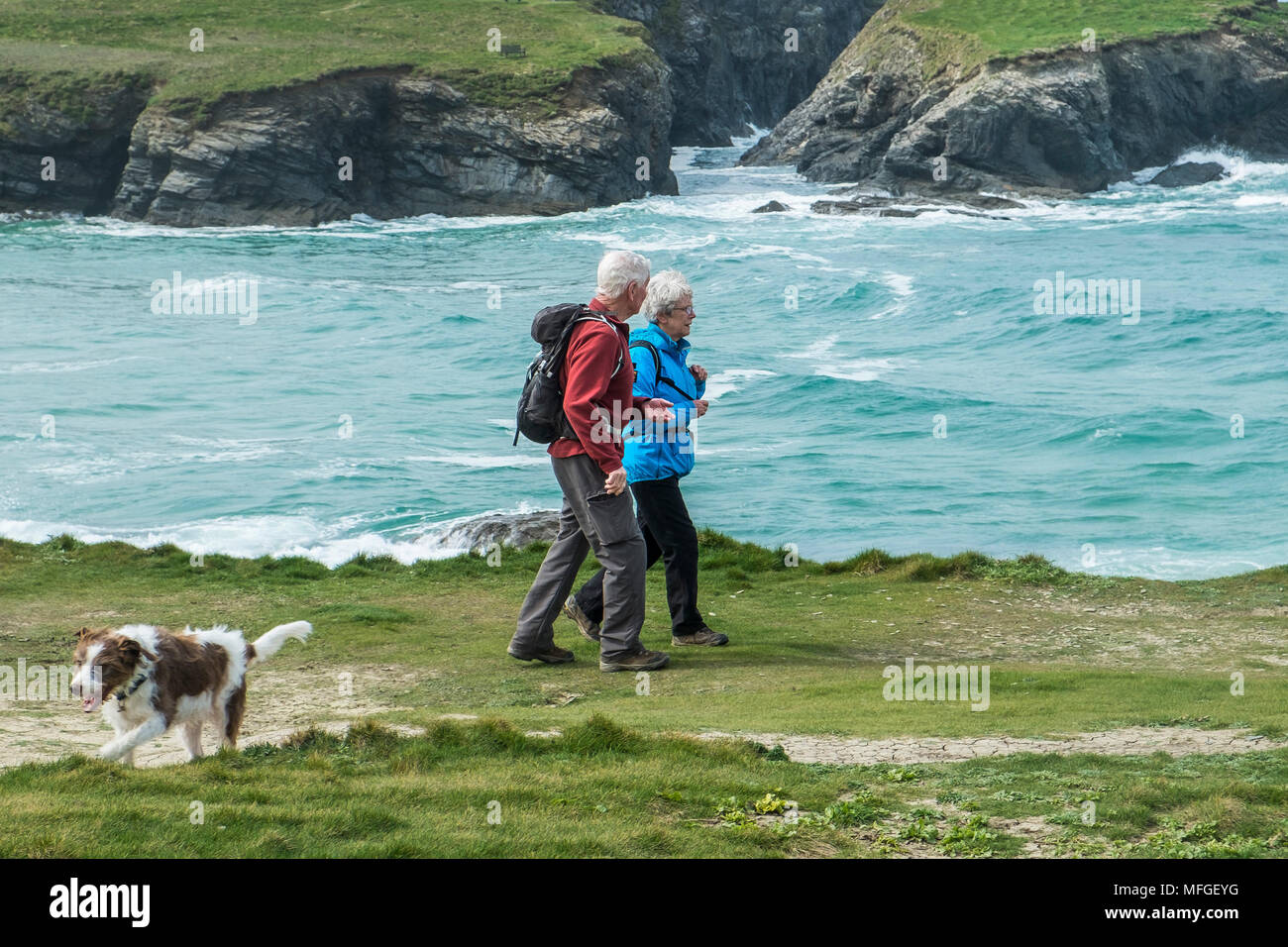Two mature walkers on the coastal path at Treyarnon Bay in Cornwall. Stock Photo