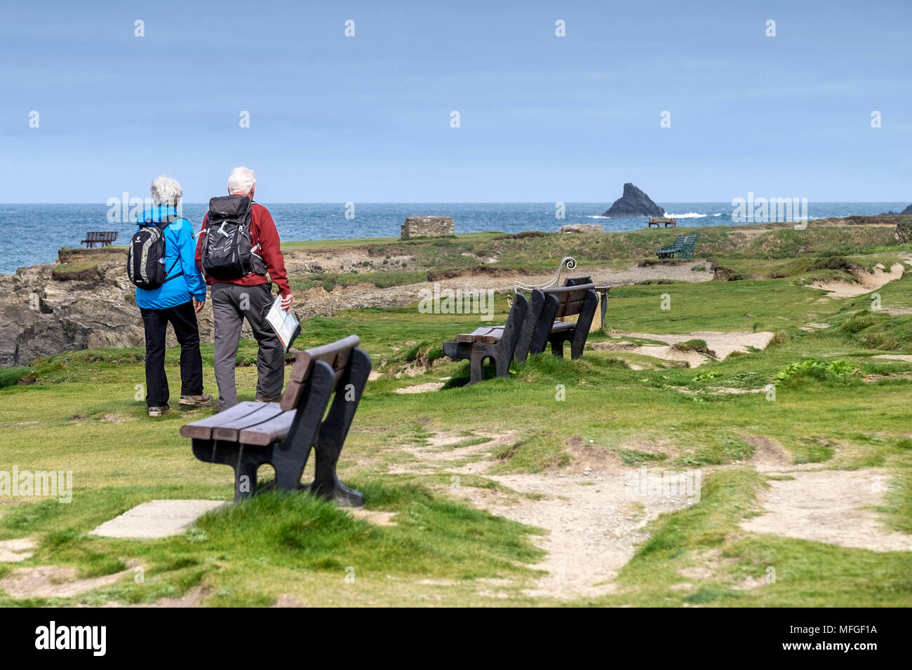 Two mature walkers on the coastal path at Treyarnon Bay in Cornwall. Stock Photo
