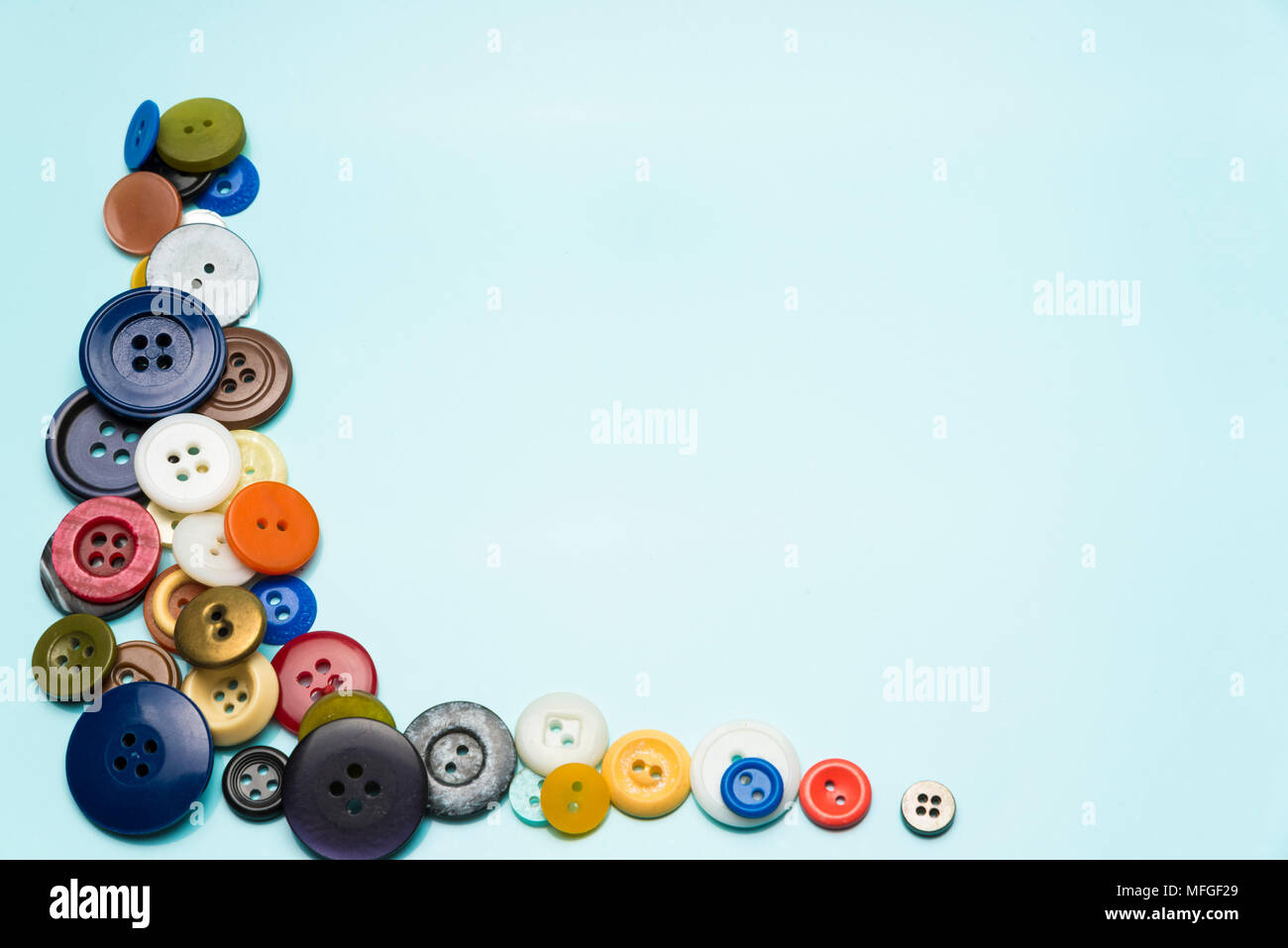 multi-colored buttons lie on a blue surface Stock Photo