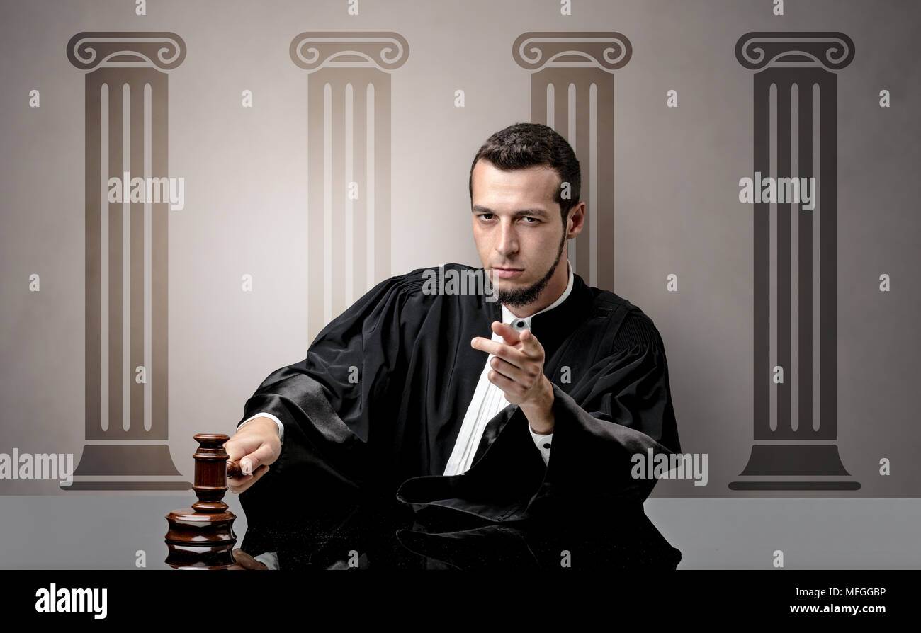Young judge in front of a courthouse symbol making decision Stock Photo