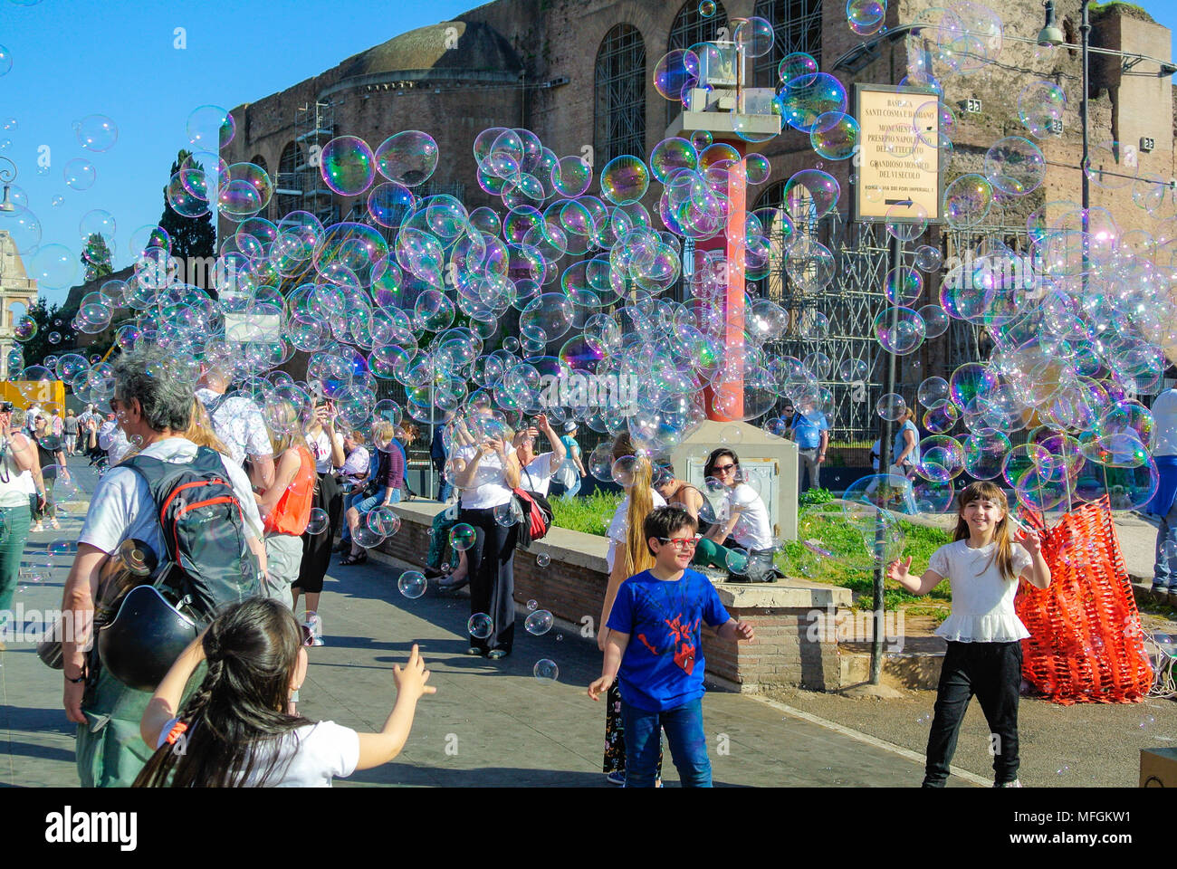 Street performance, A busker blowing giant soap bubbles with loops ...