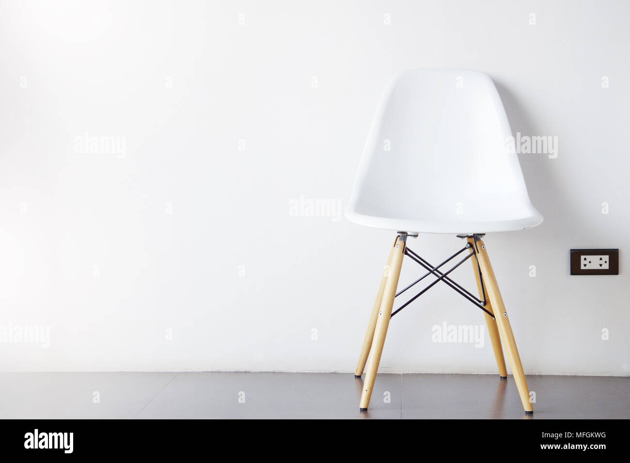 single modern white chair furniture with wood legs with wall interior
