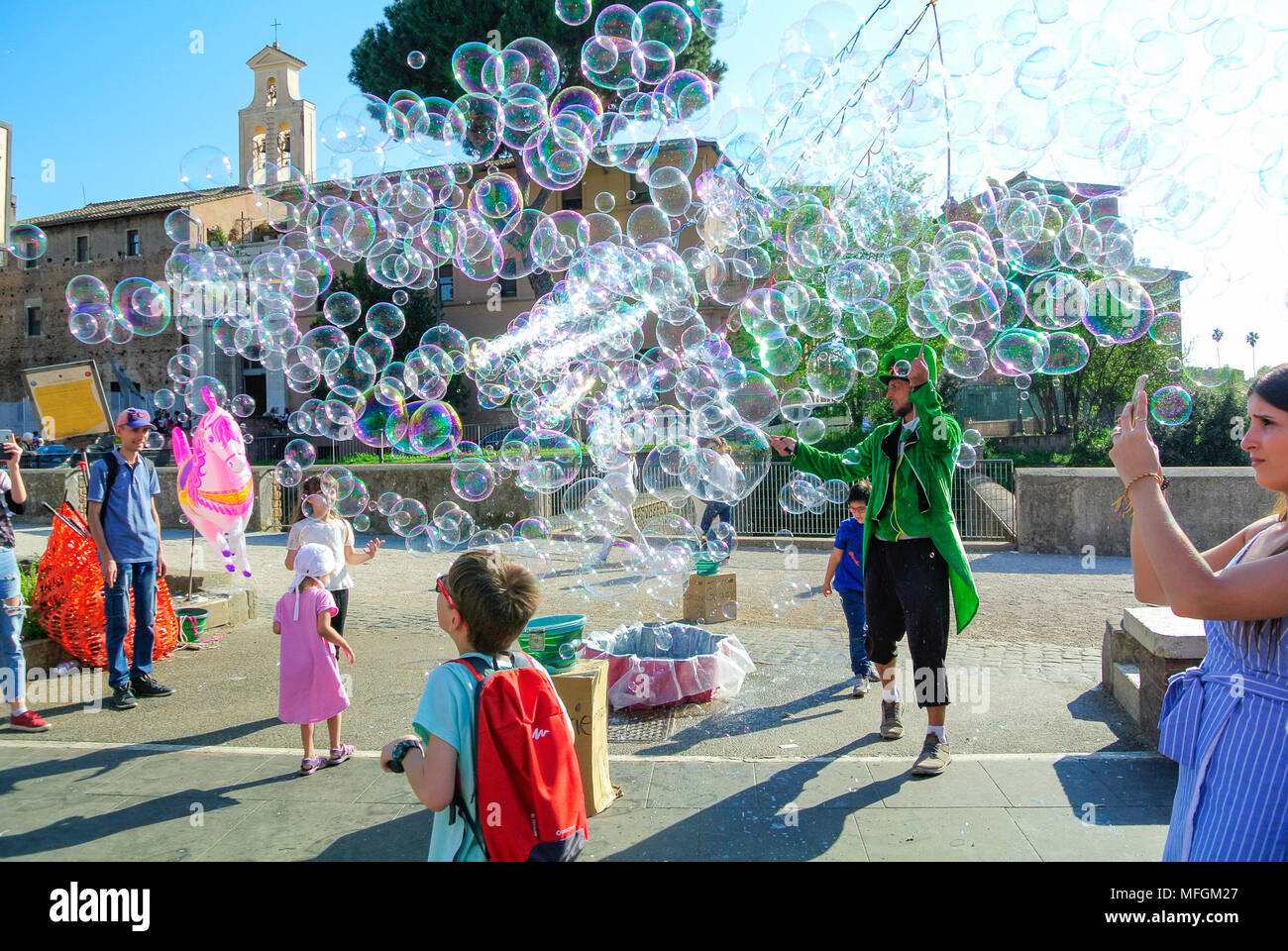 Street performance, A busker blowing giant soap bubbles with loops ...