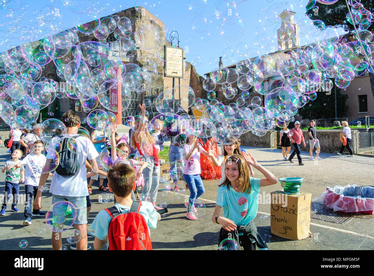 Street performance, A busker blowing giant soap bubbles with loops ...