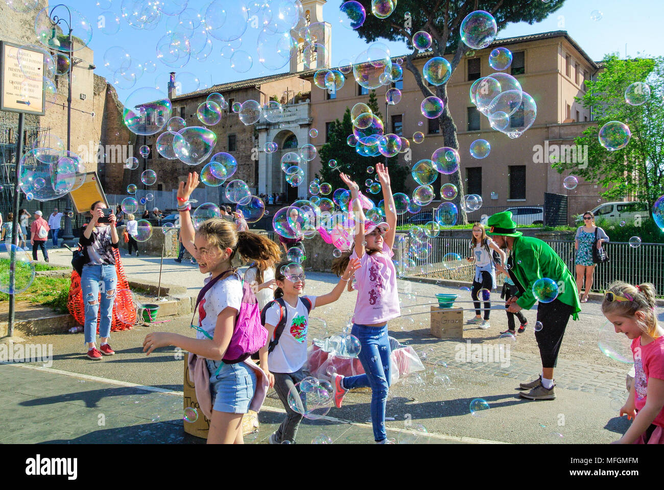 Street performance, A busker blowing giant soap bubbles with loops ...