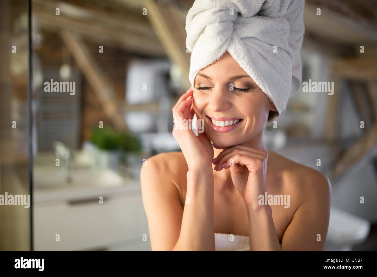 Portrait of happy beautiful woman wrapped in towels Stock Photo - Alamy