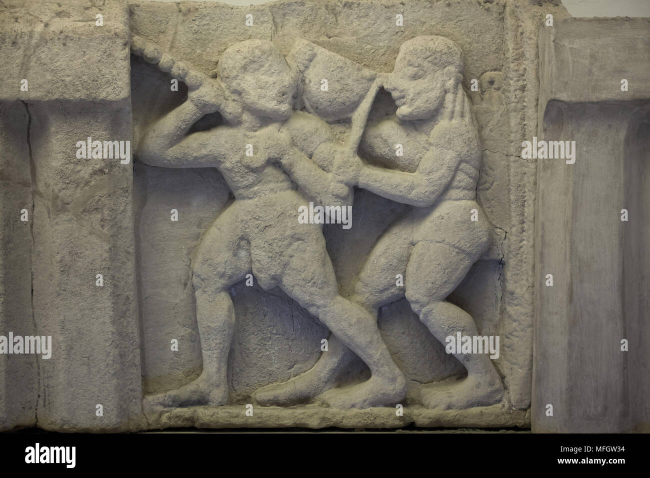 Apollo and Heracles struggle for the Delphic tripod. Archaic sandstone metope from the Heraion (First Temple of Hera) at Foce del Sele dated from the middle of the 6th century BC on display in the Paestum Archaeological Museum (Museo archeologico di Paestum) in Paestum, Campania, Italy. Stock Photo