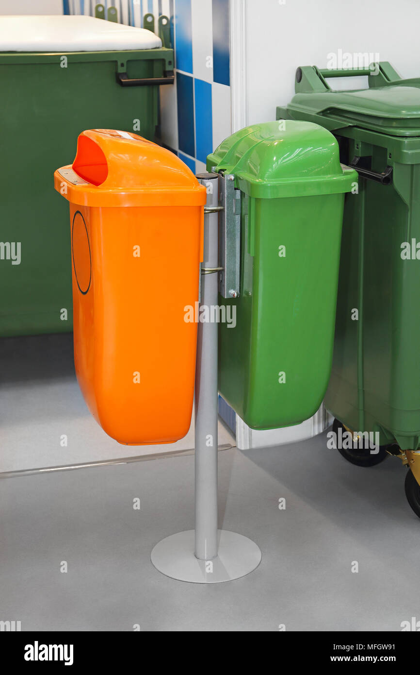 Green and Orange Plastic Public Trash Cans at Pole Stock Photo Alamy