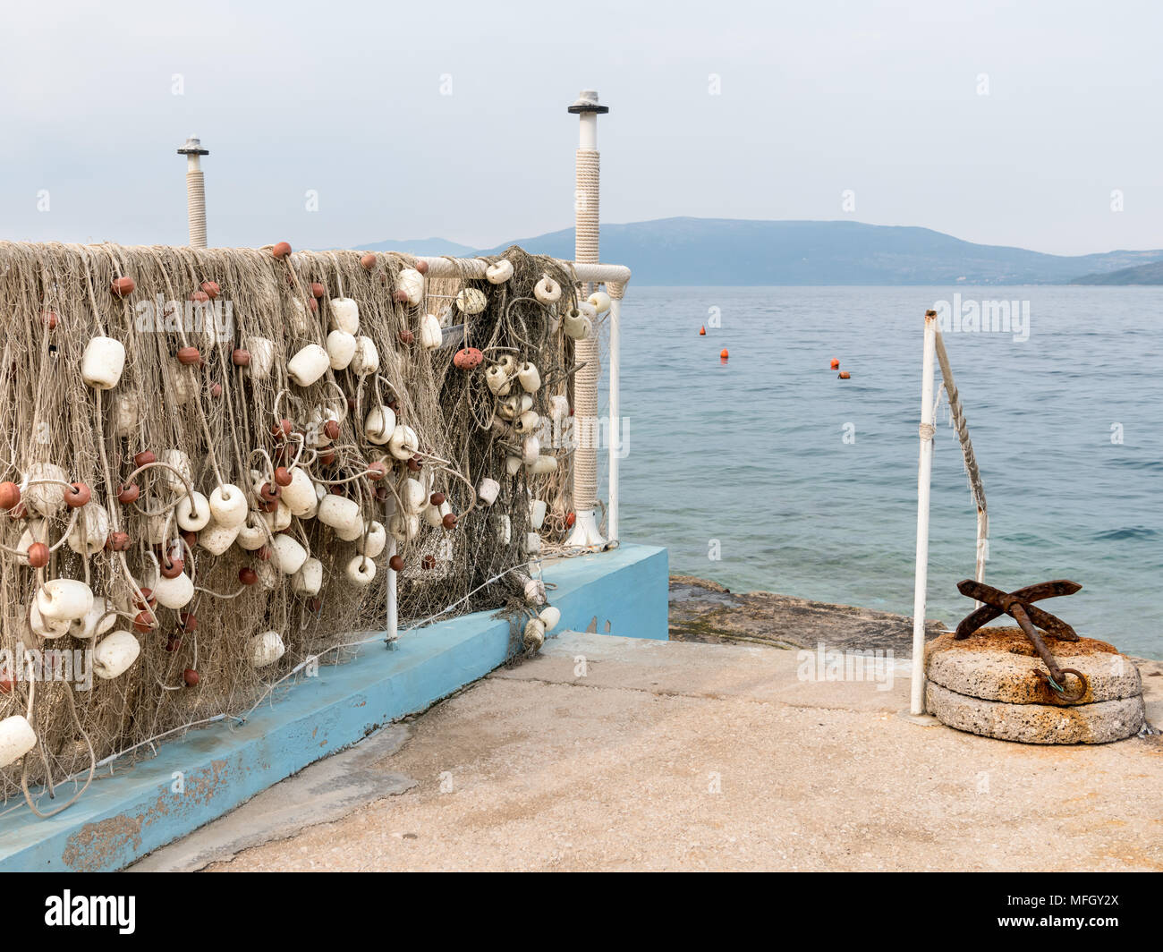 Fishing net hanging to dry near the sea in Croatia Stock Photo - Alamy