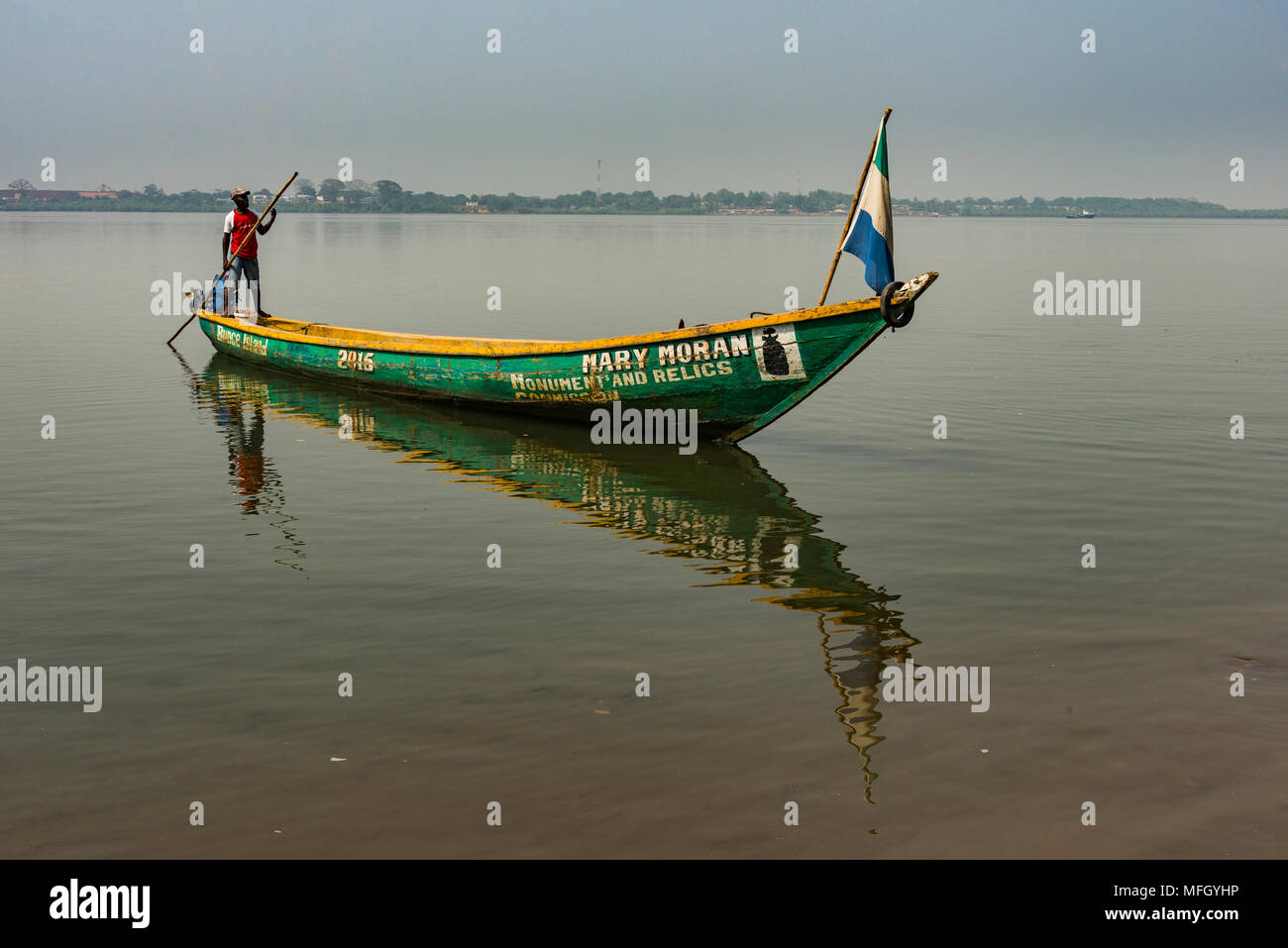 Man on his little boat before the former slave colony on Bunce island, Sierra Leone, West Africa, Africa Stock Photo