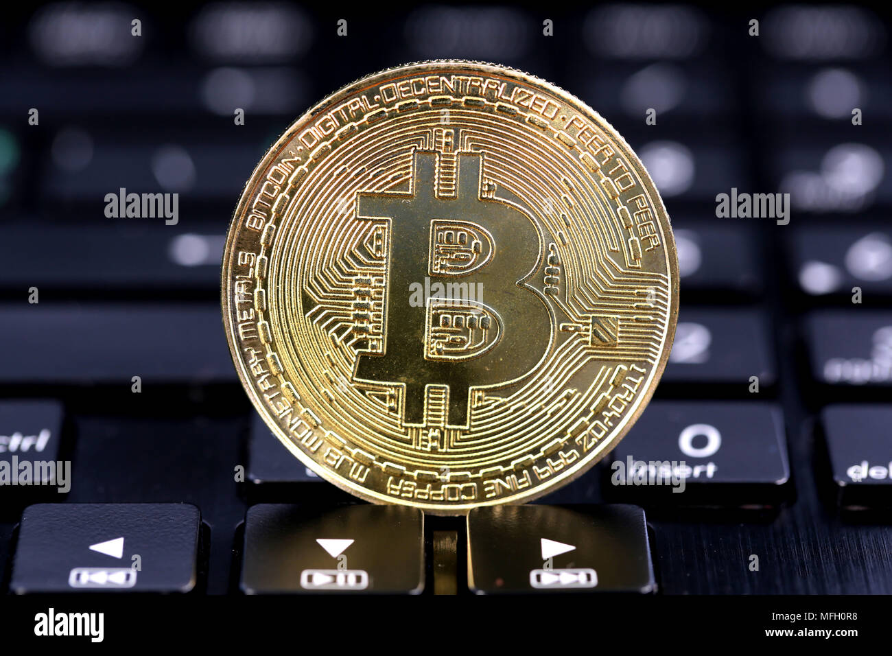Single virtual cryptocurrency money Bitcoin golden coin on United Kingdom  Pound sterling banknotes with face of Adam Smith Stock Photo - Alamy