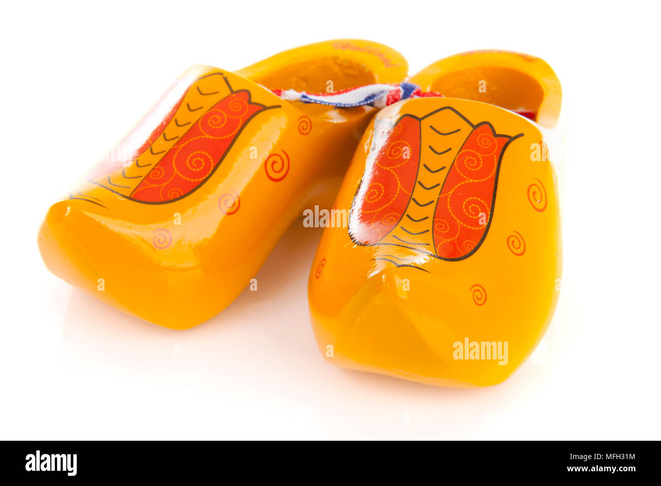 Pair of yellow Dutch wooden shoes over white background Stock Photo Alamy