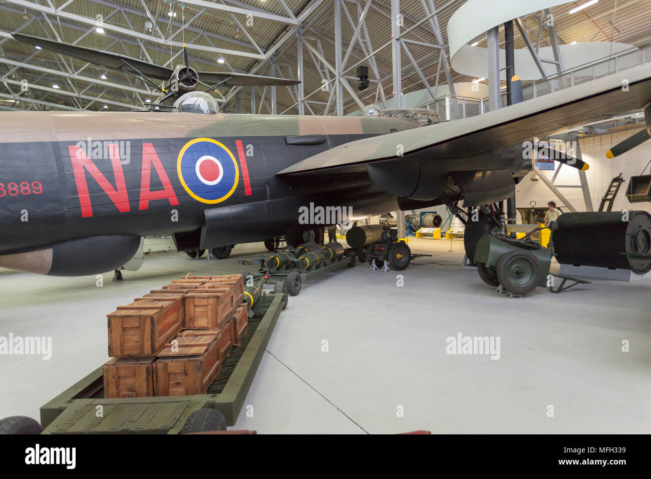 Duxford Imperial War Museum. England, UK.  A Lancaster bomber in an aircraft hanger is ready to be loaded from a train filled with bombs and cases of ammunition. Stock Photo