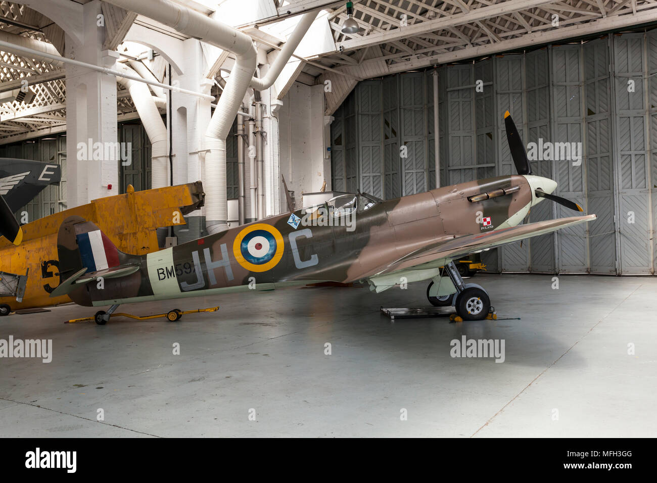 Duxford Air Museum. England, UK.  A WWII Submarine Spitfire on display in an aircraft hanger. Stock Photo